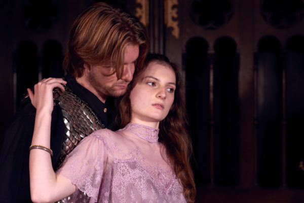 A woman wearing medieval clothes holds on to a man in search of protection in this medieval times portrait from the Game of Thrones photo session